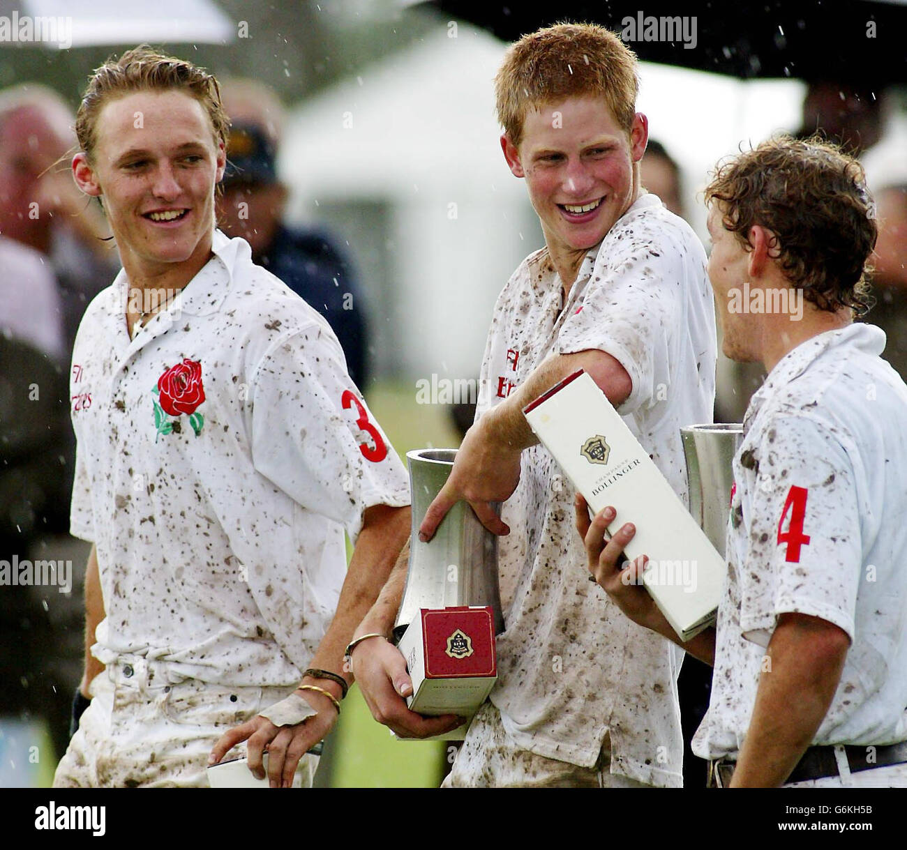 Prince Harry laughs with teammates Mark Tomlinson (left) and John Martin (right) after his Young England team beat Young Australia 6-4 in their Polo test match in Sydney's Richmond district, Australia. Stock Photo