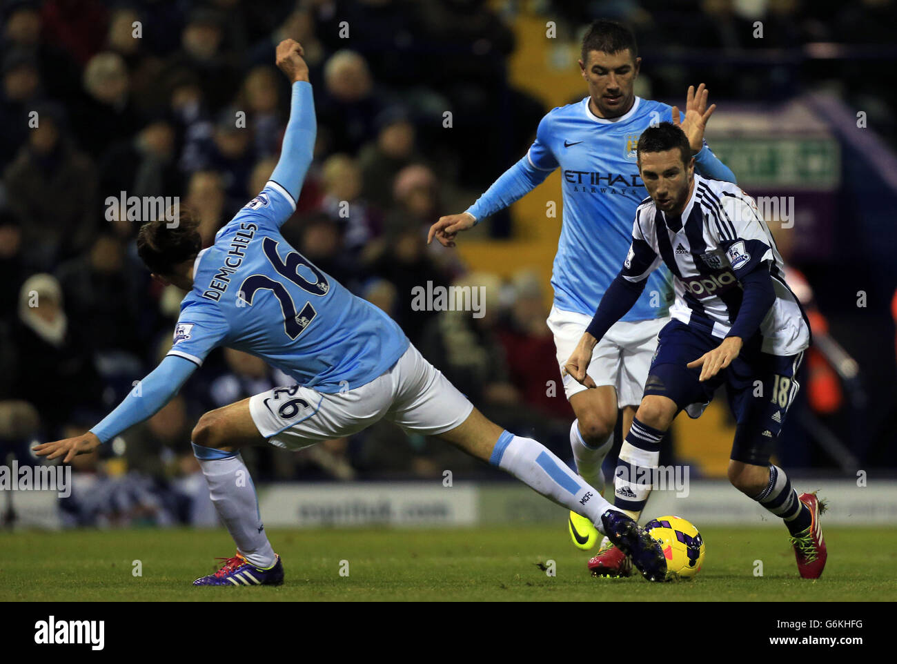 West Bromwich Albion's Morgan Amalfitano takes on Manchester City pair Martin Demichelis and Aleksandar Kolarovduring the Barclays Premier League match at The Hawthorns, West Bromwich. Stock Photo