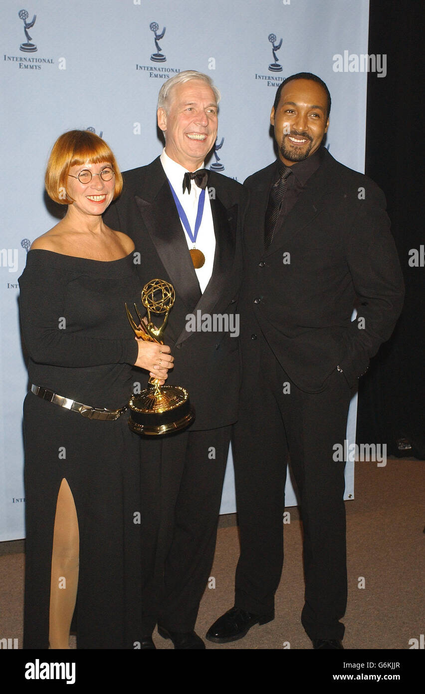 American actor Jesse L. Martin (Law & Order) (rt) presented Sonja Goslicki (lt) and Georg Feil (center) with the TV Movie/Mini-Series Emmy for the German show 'Mein Vater (Coming Home:' at the 31st International Emmy Awards at the New York Hilton in New York City, USA. Stock Photo