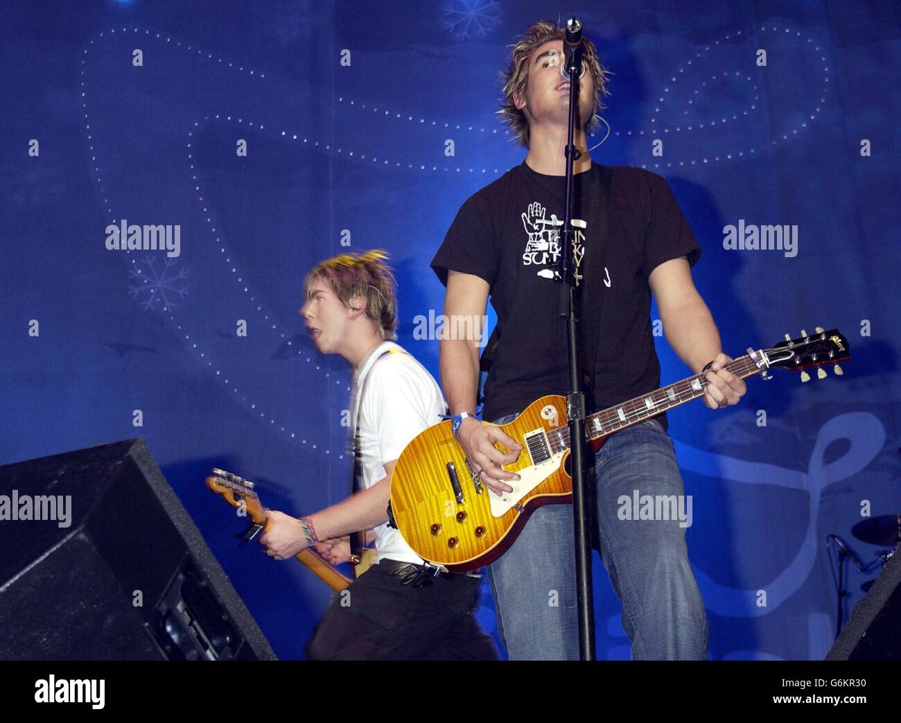 Busted performing on stage during Capital FM's Christmas Live music concert, in support of Help a London Child, held at Earl's Court in west London. Stock Photo