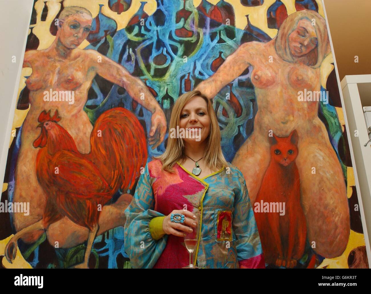 Rolf Harris' daughter Bindin standing in front of her painting entitled 'Alchemy' during the launch party of Lang Gallery At The Factory in Shoreditch, east London . Stock Photo
