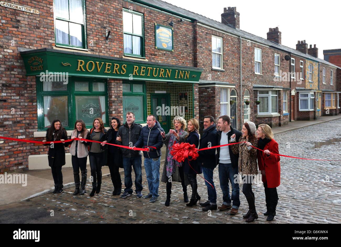 Cast members from Coronation Street stand behind a ribbon on the new set during a photocall at Media City, Manchester. Stock Photo