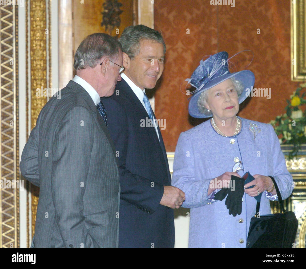 Queen Elizabeth II, America's President George Bush (centre) and US Ambassador William Farish during a tour of the Queen's Gallery at Buckingham Palace, at the start of the President's state visit to Britain. Later, Mr Bush was going on to make a speech at the Banqueting Hall in Whitehall and visit the US Embassy. Stock Photo