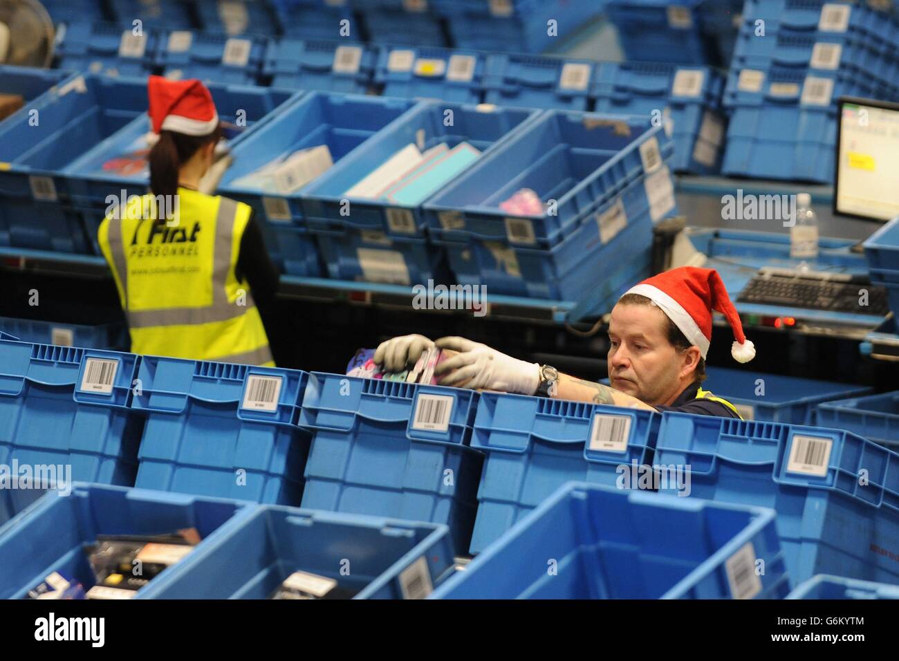 Workers prepare orders for delivery at the Argos distribution centre