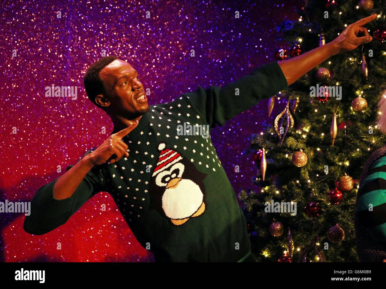Wax figure of Usain Bolt as it dons a Christmas sweater to show support(01)