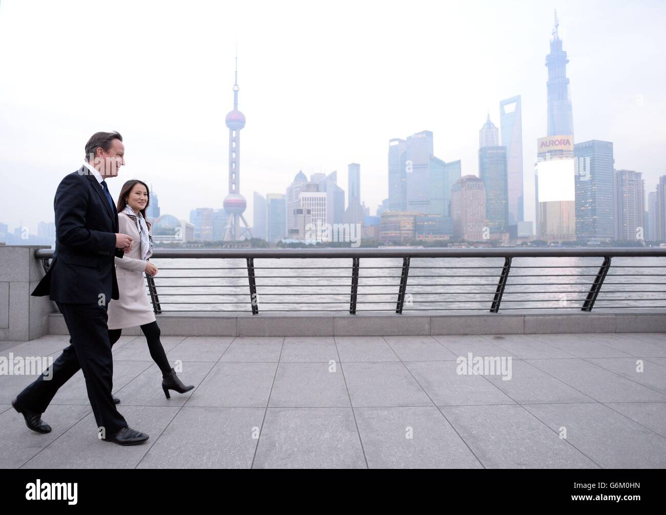 Prime Minister David Cameron walks along The Bund with Lisa Pan, Vice President of Rekoo, one of Asia's largest social gaming companies, in Shanghai. Mr Cameron is in China for a three day visit taking in the capital, Shanghai and Chengdu with an accompanying 120 strong business delegation. Stock Photo