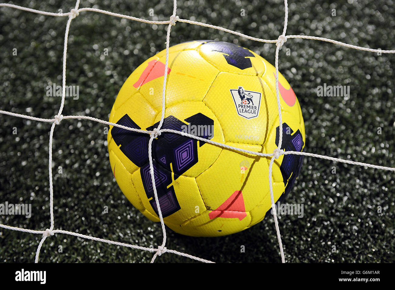 Soccer - Barclays Premier League - Fulham v Tottenham Hotspur - Craven Cottage. A yellow Mitre football behind netting. Stock Photo
