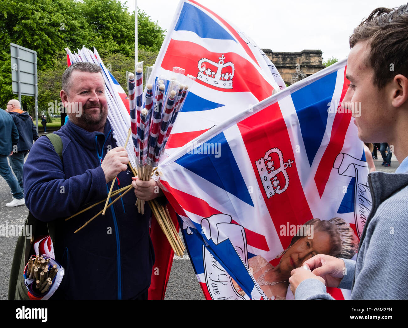 Man selling union jack flags at  Orange Walk parade in central Glasgow , Scotland, United Kingdom Stock Photo