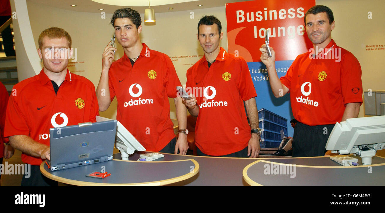 Manchester United's (from left) Paul Scholes, Cristiano Ronaldo, Ryan Giggs and Roy Keane mark the club's renewed sponsorship deal with mobile telephone company Vodafone by trying out their latest telecoms technology in their Oxford Street store in London. Stock Photo