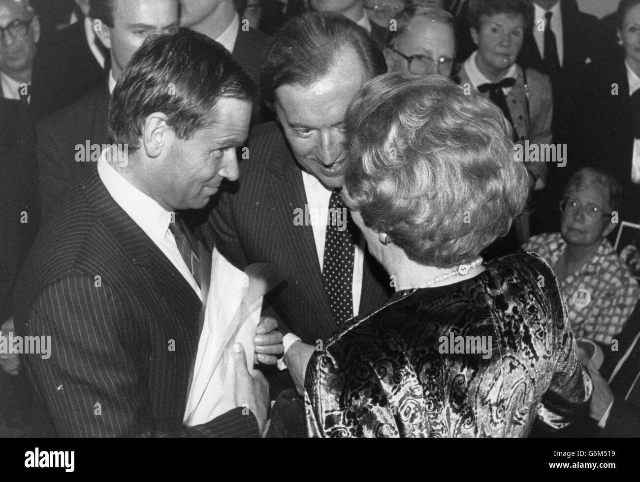 Prime Minister Margaret Thatcher talks to former Conservative Party deputy chairman Jeffrey Archer (left) and broadcaster David Frost, at the opening of Gemma Levine's photography exhibition at the Barbican Centre in London. *Low res scan - hi-res version available on request* Stock Photo