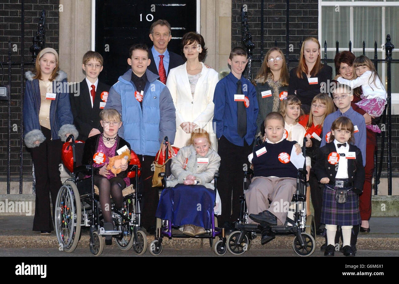 The Prime Minister Tony Blair and his wife Cherie with the Woman's Own Children of Courage 2003 outside 10 Downing Street, London. In all rows the children are listed from left to right. Front row seated; Laura Brewin from Leicester, Melissa Craven from Stockport, Steven O'Shea from Southend -On-Sea, Samuel Bell from Glasgow. Middle row; Kirsty Carlisle from Preston, John Lyons from Sevenoaksin Kent, Nicolas Hyslop from Midlothian, Liam Southall from Dudley, Bethan Ramm from Wrexham (pigtails), Emma Mawdsley from Ripon, Shay Corrie from Tyne and Wear. Rear right row Rachel Mawdsley ( sister Stock Photo