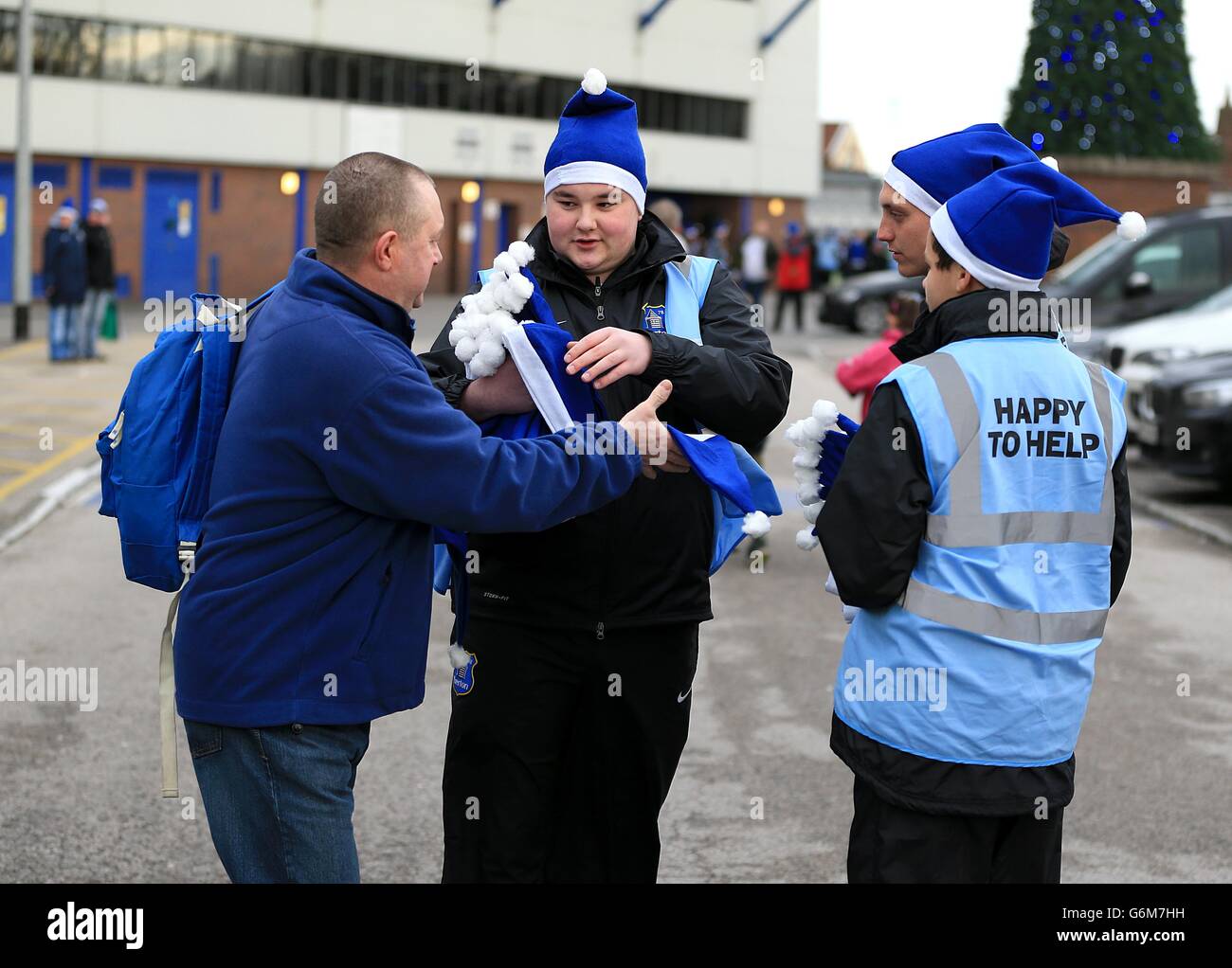 Soccer - Barclays Premier League - Everton v Fulham - Goodison Park. Everton helpers hand out blue Santa hats outside Goodison Park Stock Photo