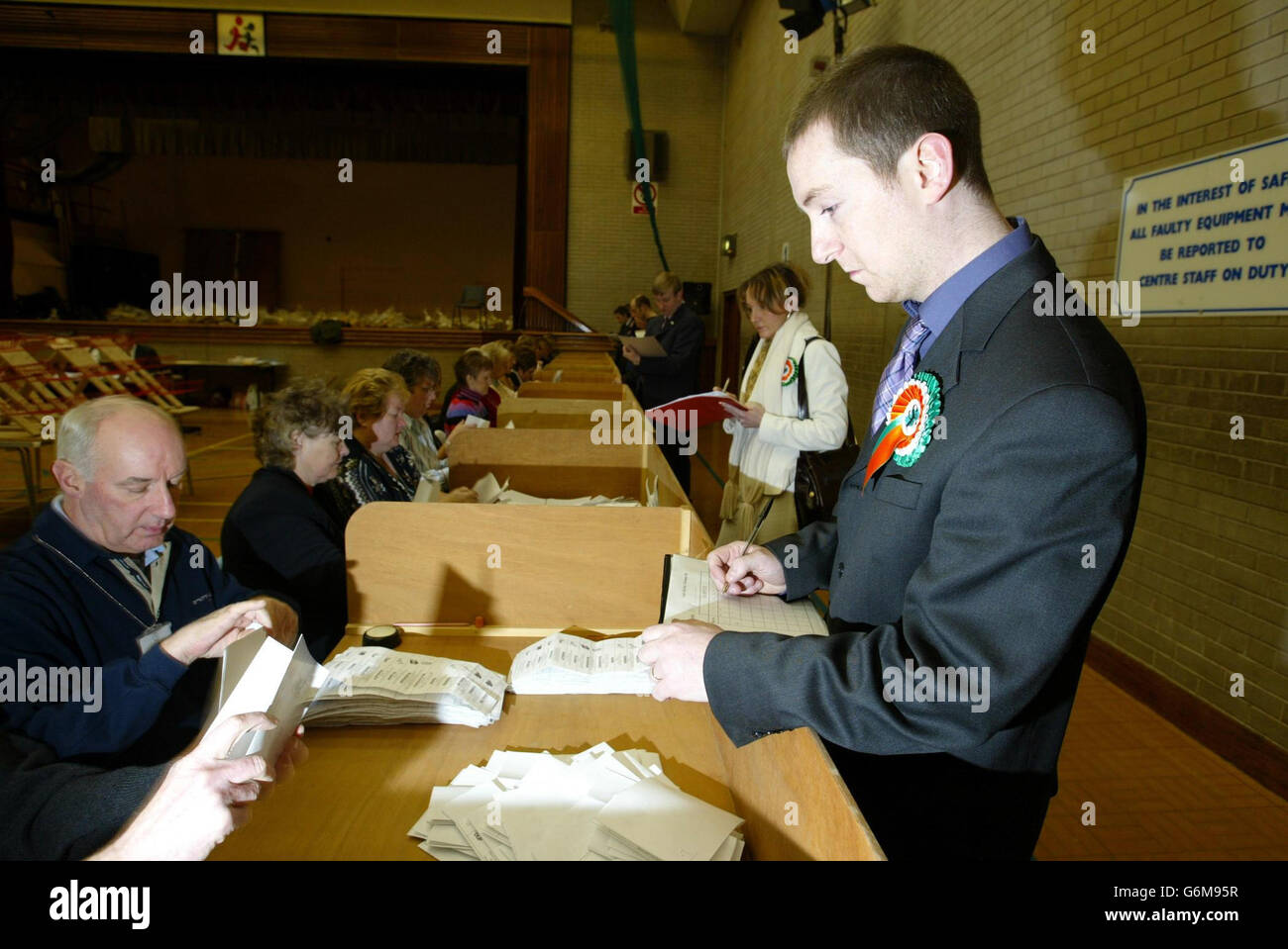 Philip McGuigan of Sinn Fein looks on as election papers are counted at the North Antrim count at Ballymoney, for the Northern Ireland Assembly. David Trimble's Ulster Unionists and the Rev Ian Paisley's Democratic Unionists are running neck-and-neck in a tight Northern Ireland Assembly Election contest, an Exit poll claimed today. The poll, which surfaced two hours before counting for the Assembly's 108 seats got under way across Northern Ireland, also put Sinn Fein four points ahead of its rival nationalist party, the SDLP. Stock Photo