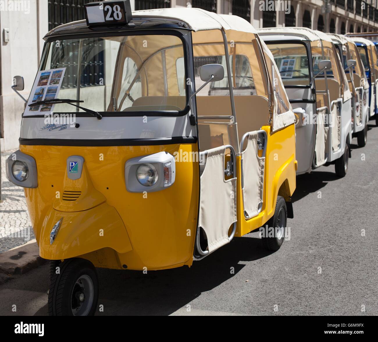 A colorful Tuk Tuk in Lisbon, Portugal. Adopted from Thailand and used by tourists and sightseers. Stock Photo