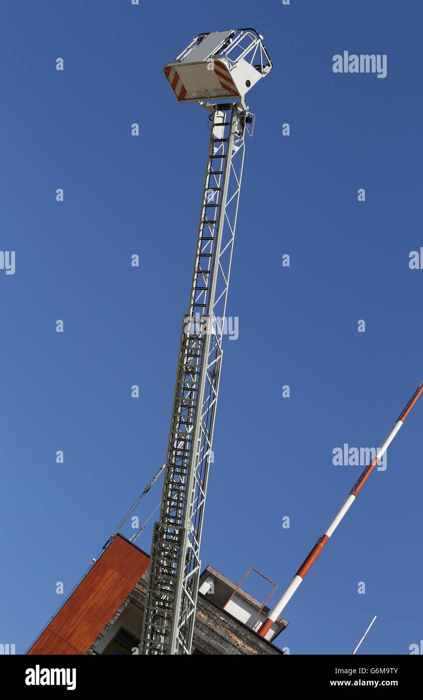 big elevator cage of fire truck with big ladder of firemen Stock Photo