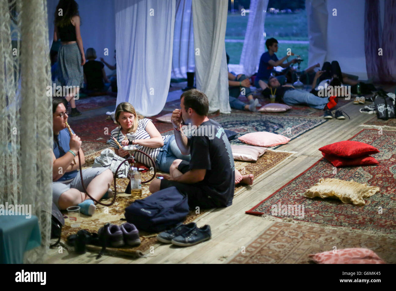 People in the Nargila Chill Out zone resting by smoking nargilas on the third day of 11th INmusic festival n Zagreb, Croatia. Stock Photo
