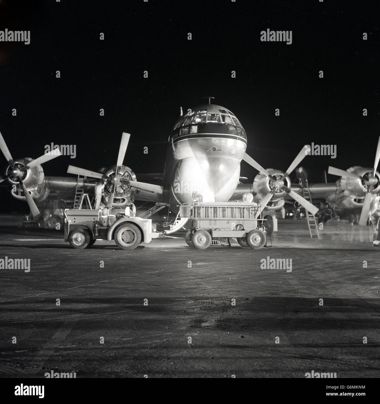 1950s, historical, The 'Clipper Constitution' Boeing 377 Stratocruiser aircraft being serviced at Dublin Airport at night. A Pan American World Airways (PAA) airplane it had four propeller-driven engines. Stock Photo
