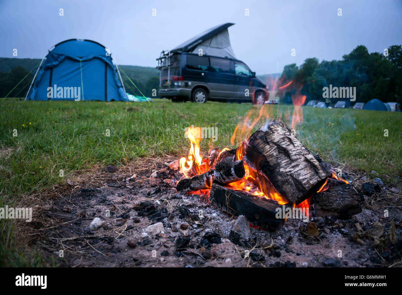 Burning log fire in a camp site on the South Downs, West Sussex, UK Stock Photo