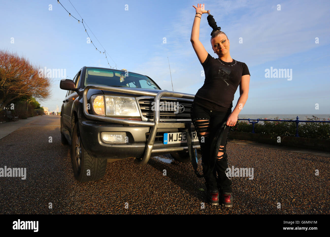 Circus of Horrors performer Anastasia IV pulls a four tonne vehicle along the seafront in Eastbourne, Sussex, as the circus prepare to perform a series of shows across the region later this month. Stock Photo