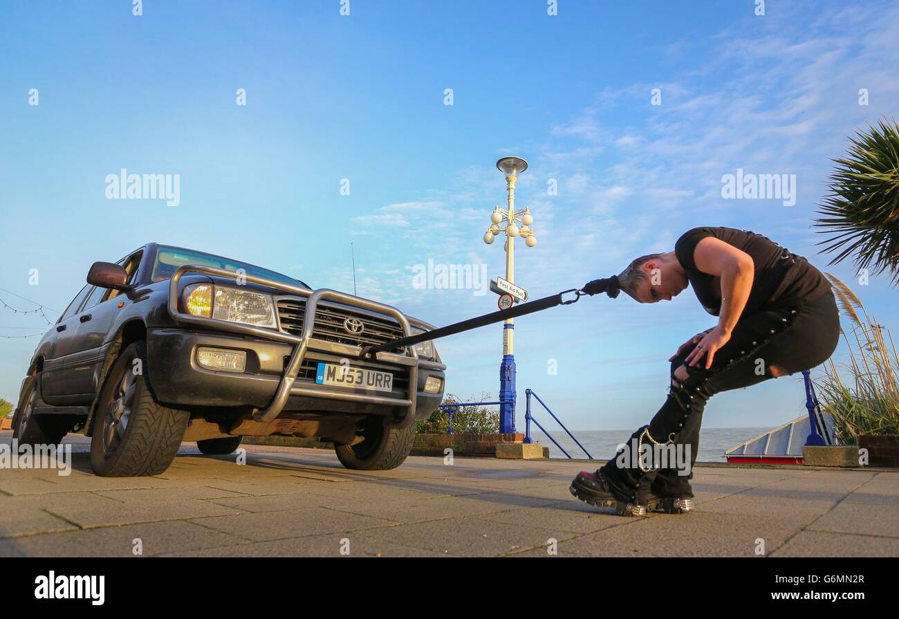 Circus of Horrors performer pulls car with hair Stock Photo