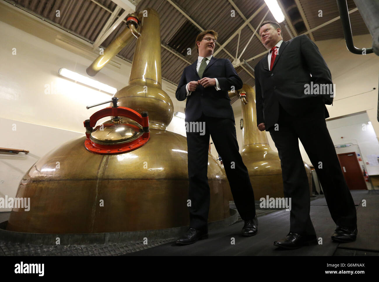 New Scotch Whisky Association Chief David Frost (right) talks to Chief Secretary to the Treasury Danny Alexander in the stills room during a visit to Benromach distillery in Forres, near Inverness, as he launches the Spirit Drinks Verification Scheme. PRESS ASSOCIATION Photo. Picture date: Thursday January 9, 2014. See PA story POLITICS Spirits. Photo credit should read: Andrew Milligan/PA Wire Stock Photo