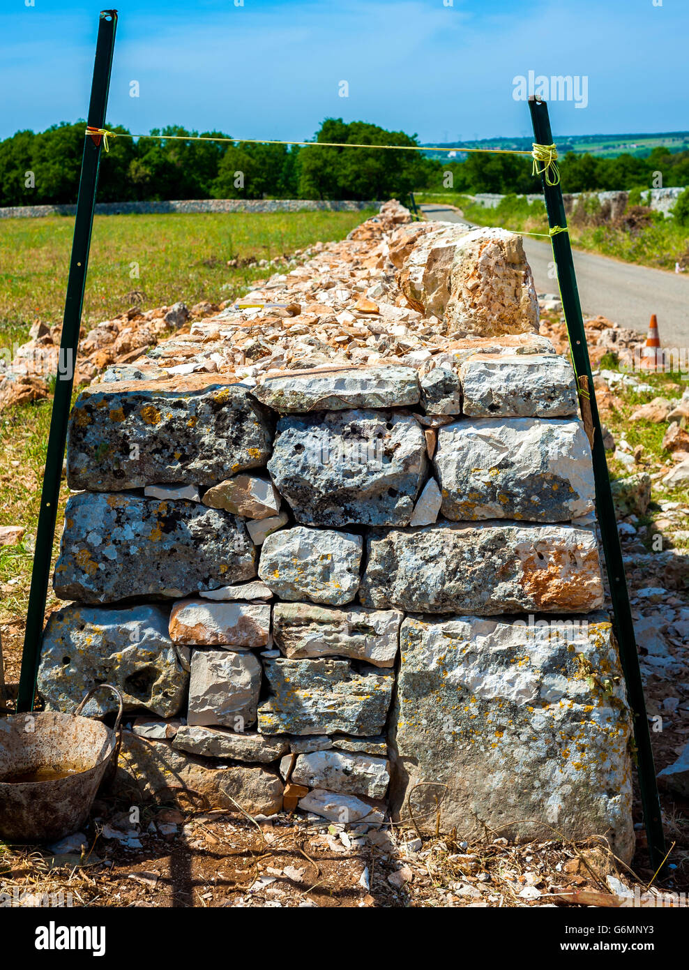 Restore drywall with stones wall in focus in the countryside of Apulia Stock Photo
