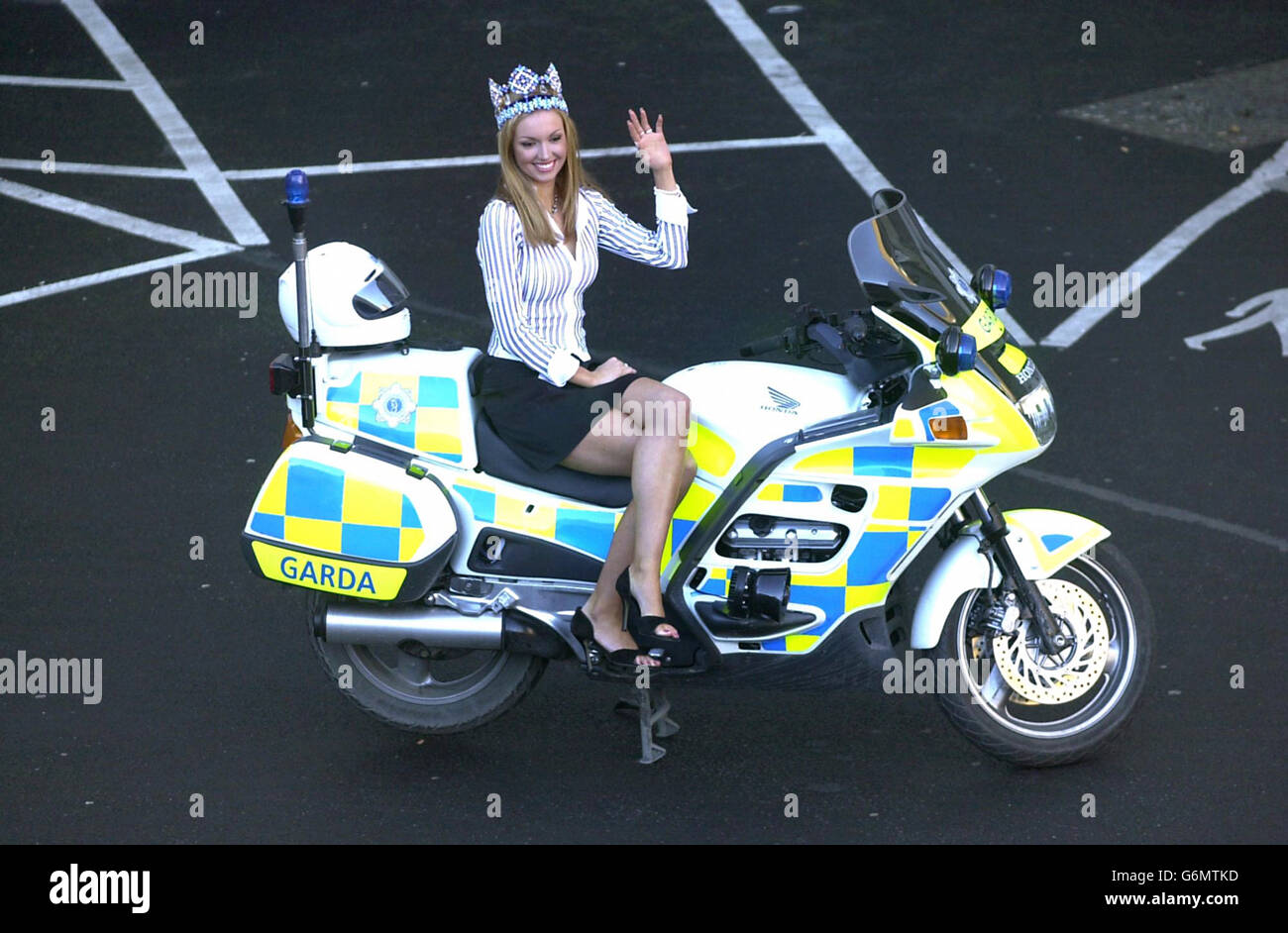 Miss World 2003 winner, Rosanna Davison poses on a Garda Honda motorcycle on her arrival at Dublin Airport. The 19-year-old art student became the first Irish contestant to claim the title when she saw off the challenge of 105 competitors in the beauty pageant at the weekend. Stock Photo