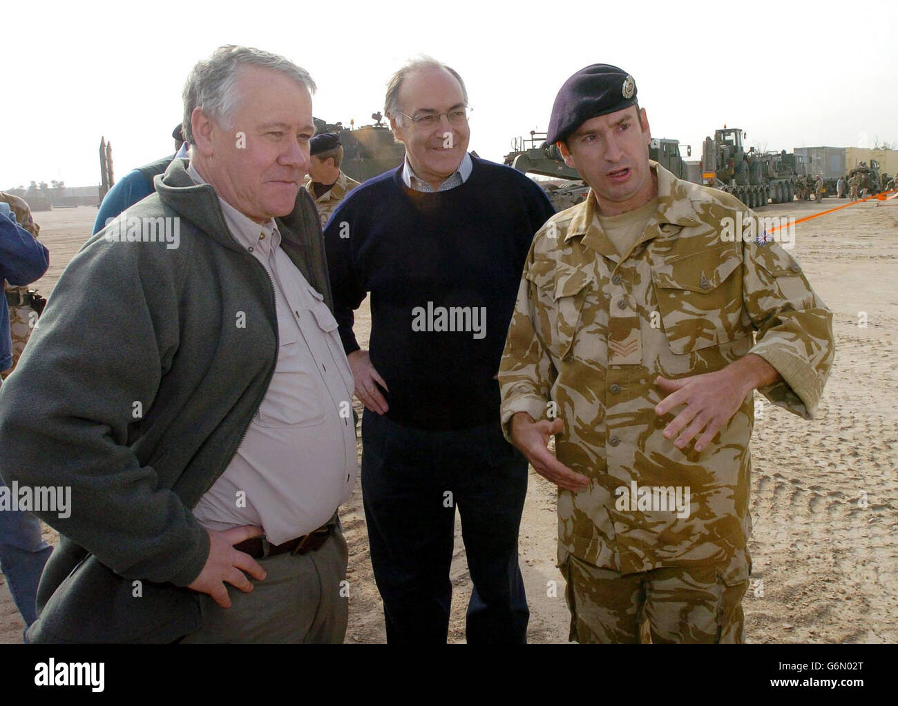 Tory leader Michael Howard (centre) and Armed Forces Minister Adam Ingram meet with Sgt. John Marley from Horden Co Durham of 15th Field Sqd. Royal Engineers at Shaibah Logistic Base. Mr Howard was joining Mr Ingram and shadow defence secretary Nicholas Soames for the last leg of a tour to raise troops' morale. Stock Photo