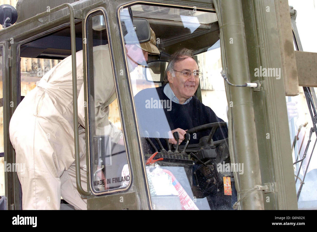Tory leader Michael Howard (right) drives a fork lift truck during his visit to Shaibah Logistic Base. Mr Howard was joining Armed Forces Minister Adam Ingram and shadow defence secretary Nicholas Soames for the last leg of a tour to raise troops' morale. Stock Photo