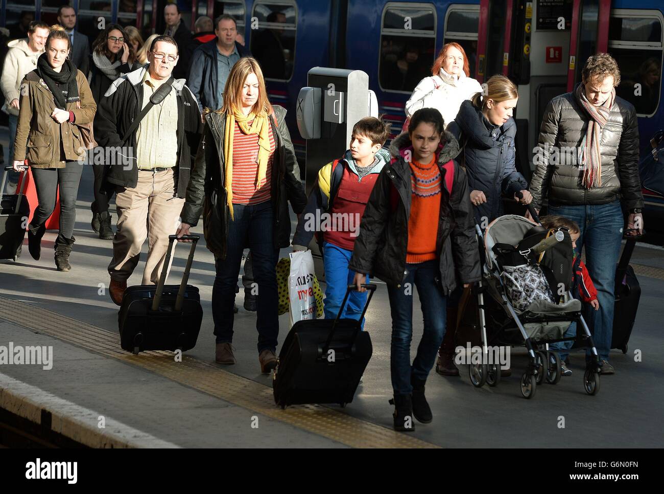 A group of travellers make their way to waiting trains as the expected ...