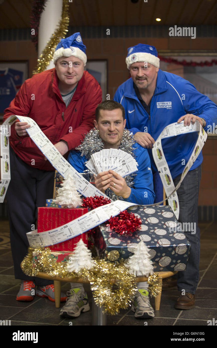 Robert Pollock (Turning point scotland homeless charity) Rangers striker Jon Daly (centre) and former player Ally Dawson (right) during a photocall to announce handing over tickets for boxing day game to the homeless at Murray Park, Glasgow. Stock Photo