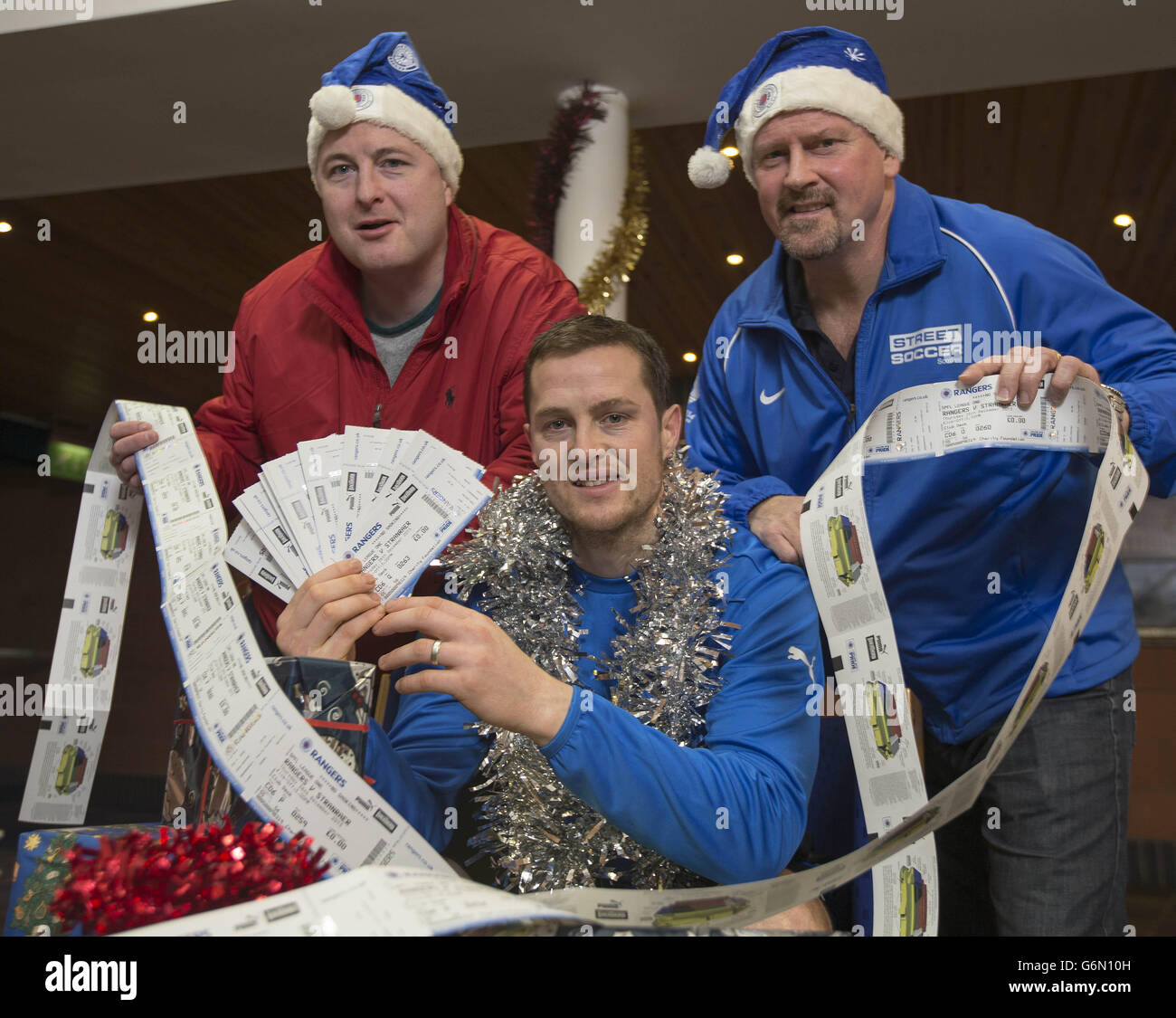 Robert Pollock (Turning point scotland homeless charity) Rangers striker Jon Daly (centre) and former player Ally Dawson (right) during a photocall to announce handing over tickets for boxing day game to the homeless at Murray Park, Glasgow. Stock Photo