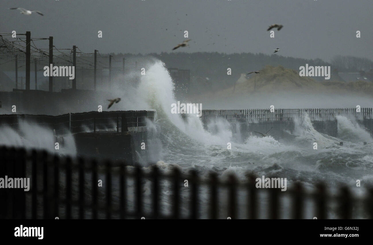 Waves hit the shore at Saltcoats in Scotland where trains were cancelled today due to the bad weather. Stock Photo