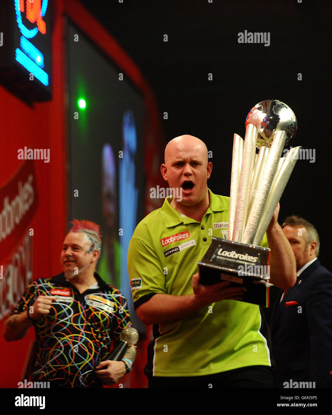 Michael Van Gerwen holds the Sid Waddell trophy after winning the Final