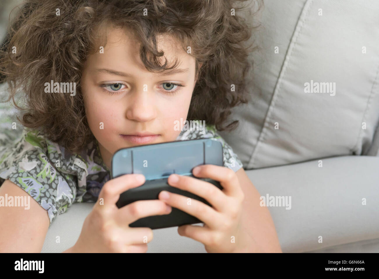 Girl playing with mobile device Stock Photo