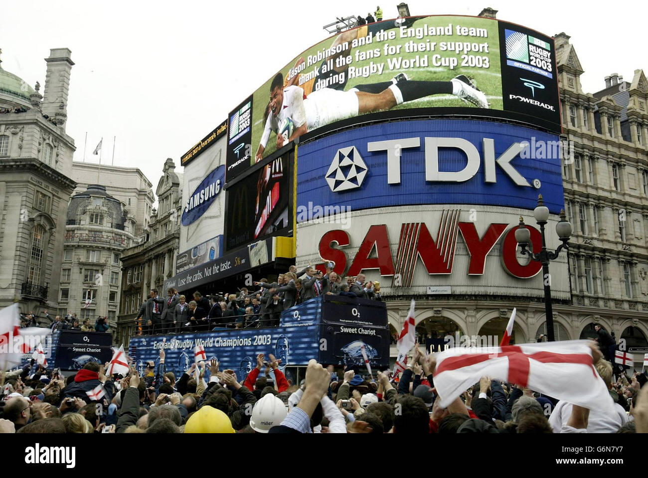 The England Rugby World Cup team during the victory parade in central London. The two open-topped buses arrived outside the National Gallery to a rapturous welcome from thousands of fans.The square was a sea of red and white flags as the nation's heroes waved to fans. Stock Photo