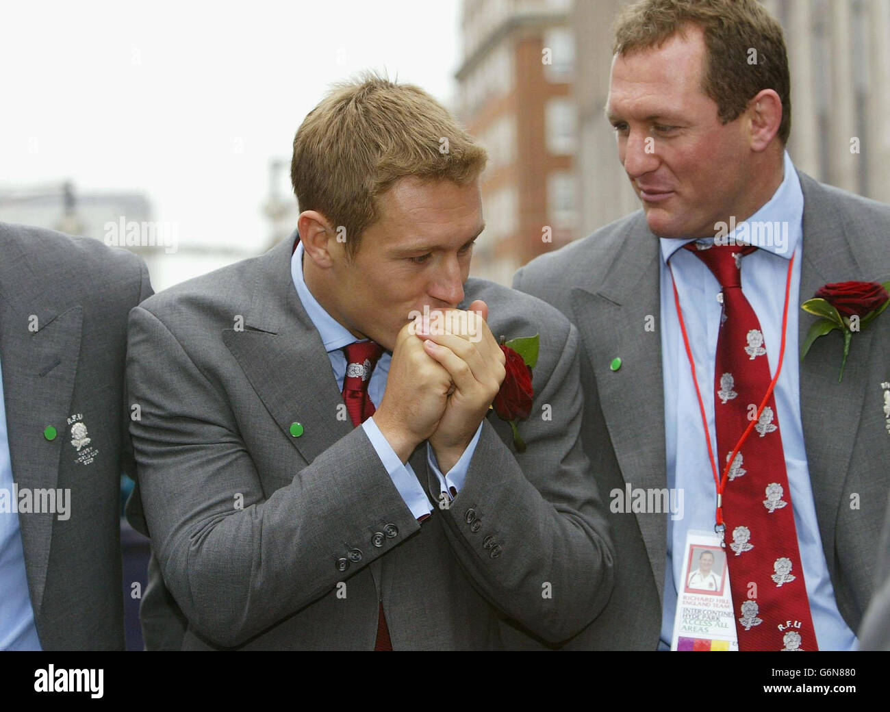 England player Jonny Wilkinson warms his hands during the England Rugby World Cup team victory parade in central London. The two open-topped buses arrived outside the National Gallery to a rapturous welcome from thousands of fans.The square was a sea of red and white flags as the nation's heroes waved to fans. Stock Photo