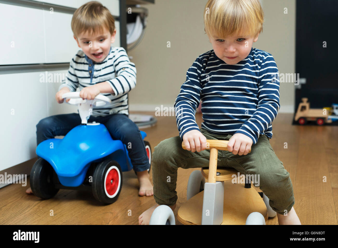 Two little boys playing at home with toy cars Stock Photo - Alamy