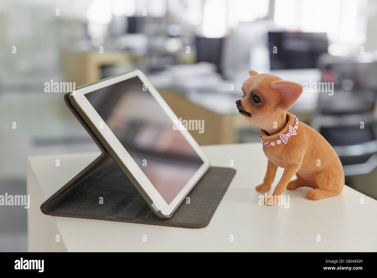 Digital tablet and wobbler on ledger in modern office Stock Photo