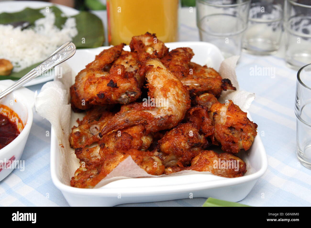Close up of Marinated fried chicken in white serving platter Stock Photo
