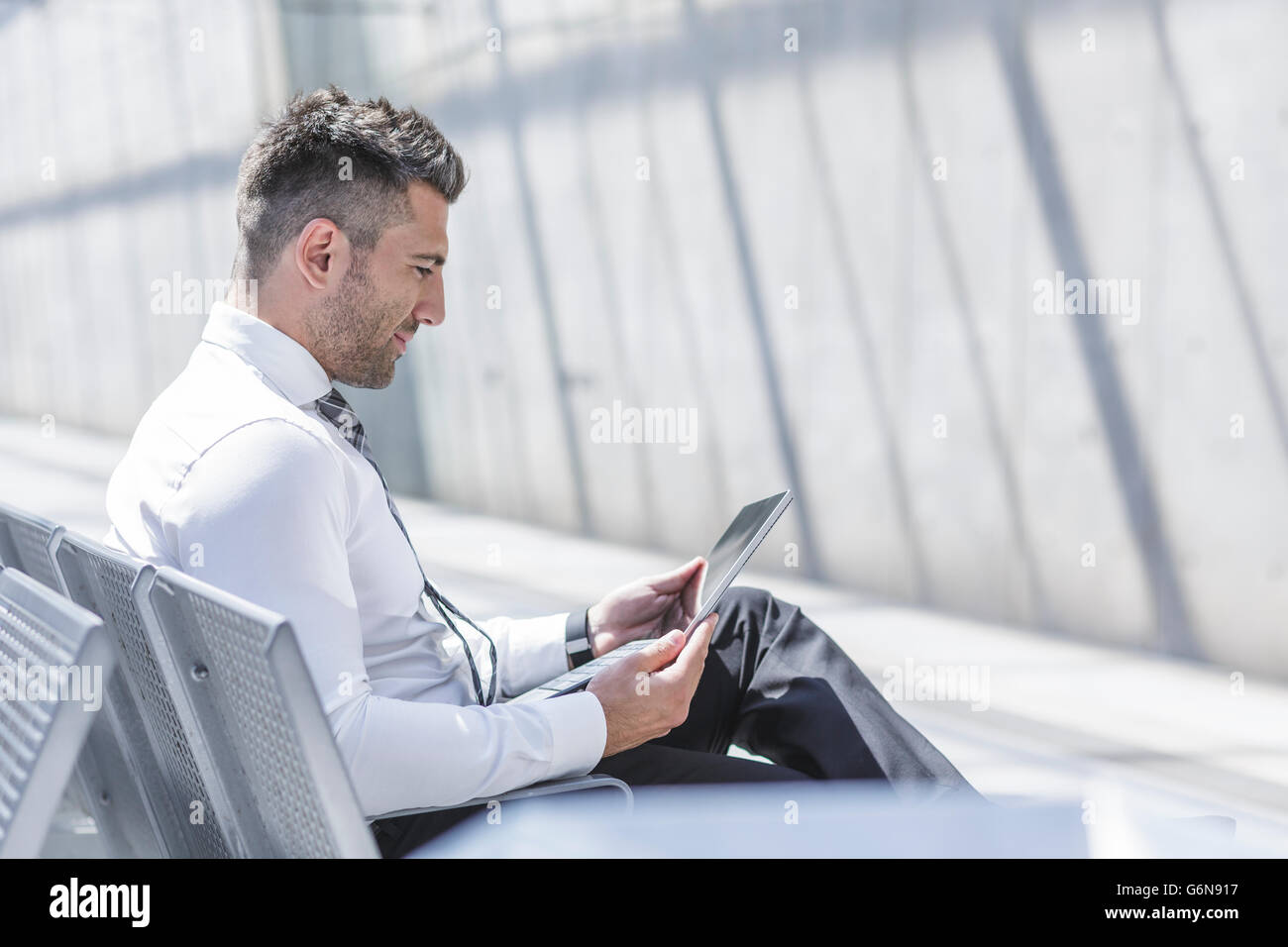 Businessman using digital tablet at waiting area Stock Photo