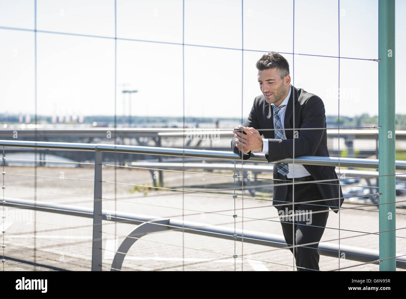 Businessman with cell phone at the airport Stock Photo
