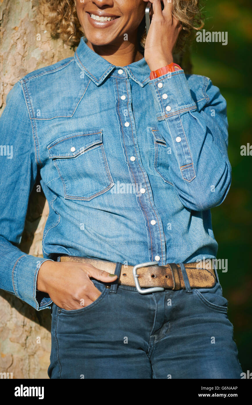 Woman wearing denim shirt, partial view 