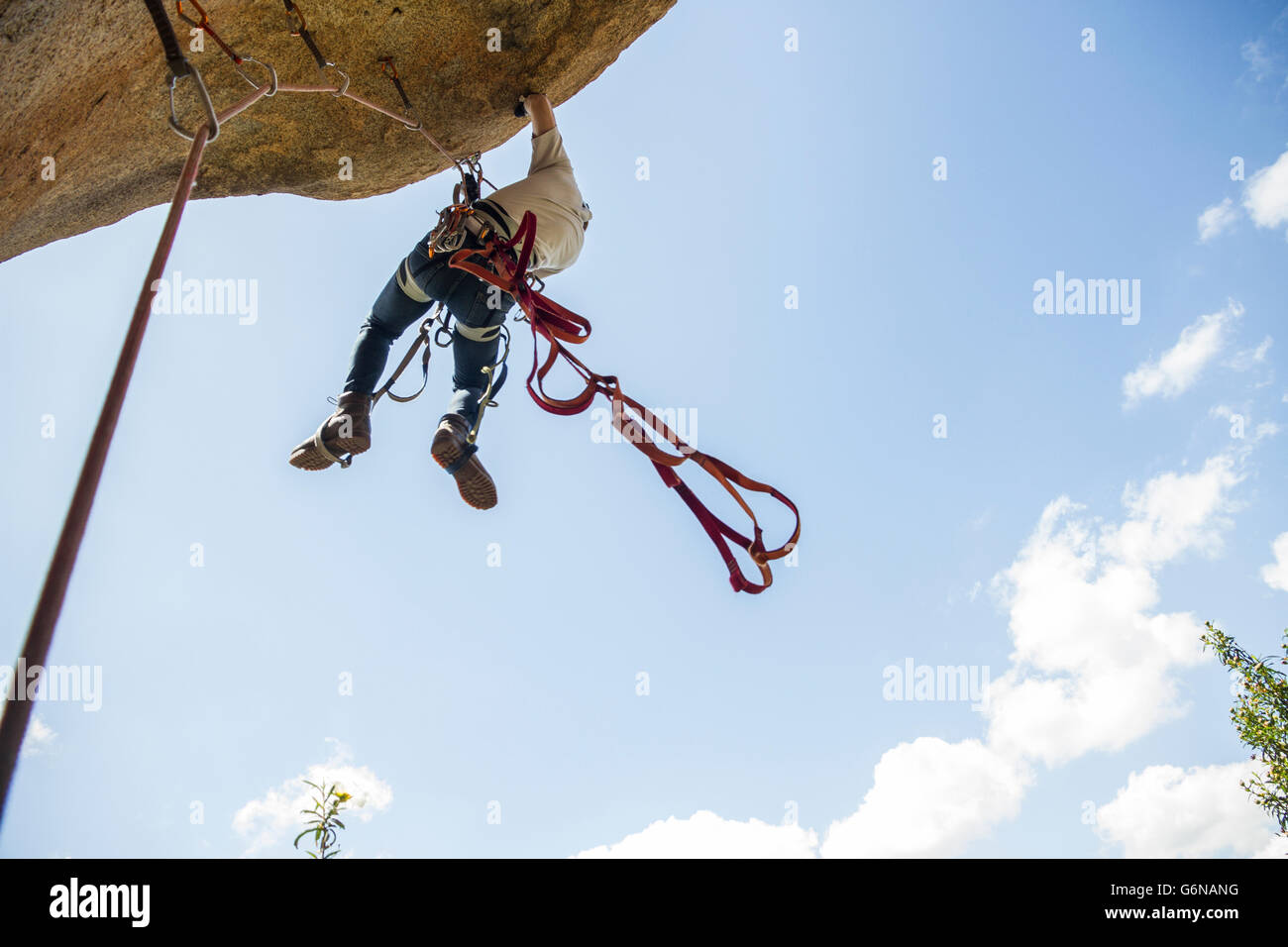 Climber climbing using aid climbing techniques Stock Photo