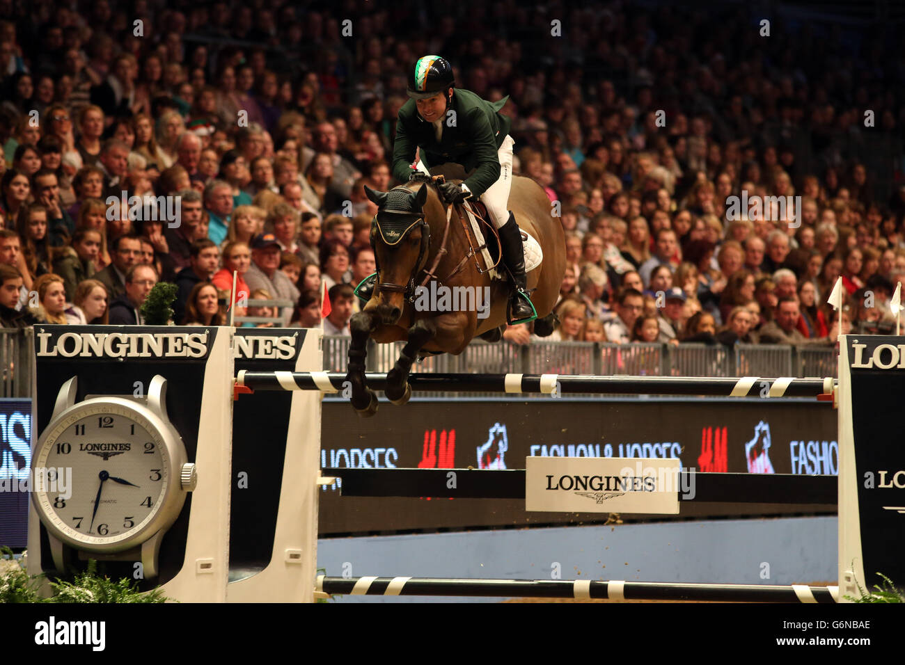 Ireland's Cian O'Connor riding Cooper competes in the Longines FEI World Cup during day six of The London International Horse Show at the Olympia Exhibition Hall, London. Stock Photo