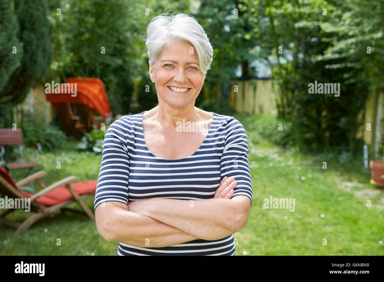 Portrait of smiling woman in the garden Stock Photo - Alamy