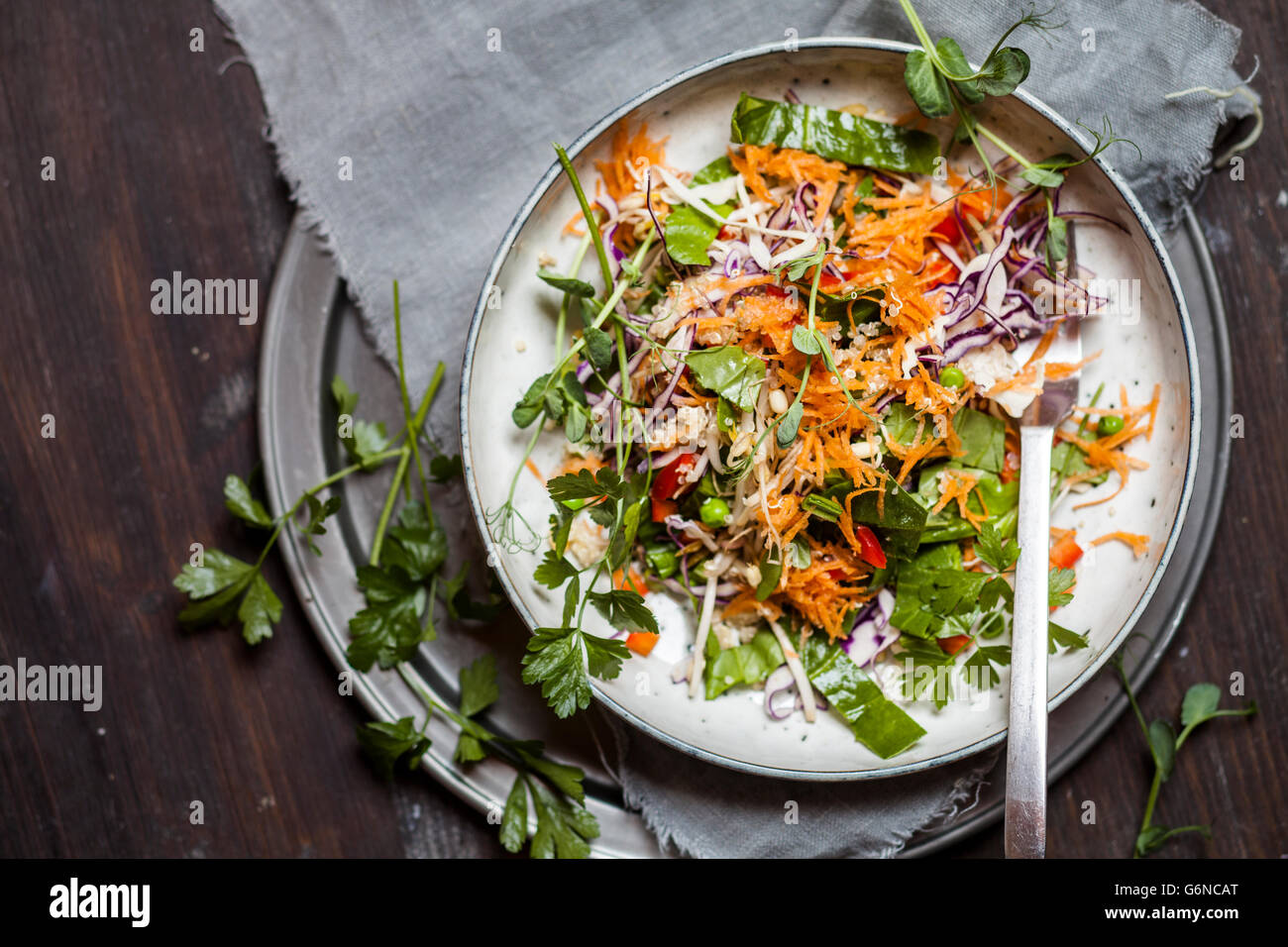 Rainbow salad with spinach leaves, peas, carrots, mung bean sprouts