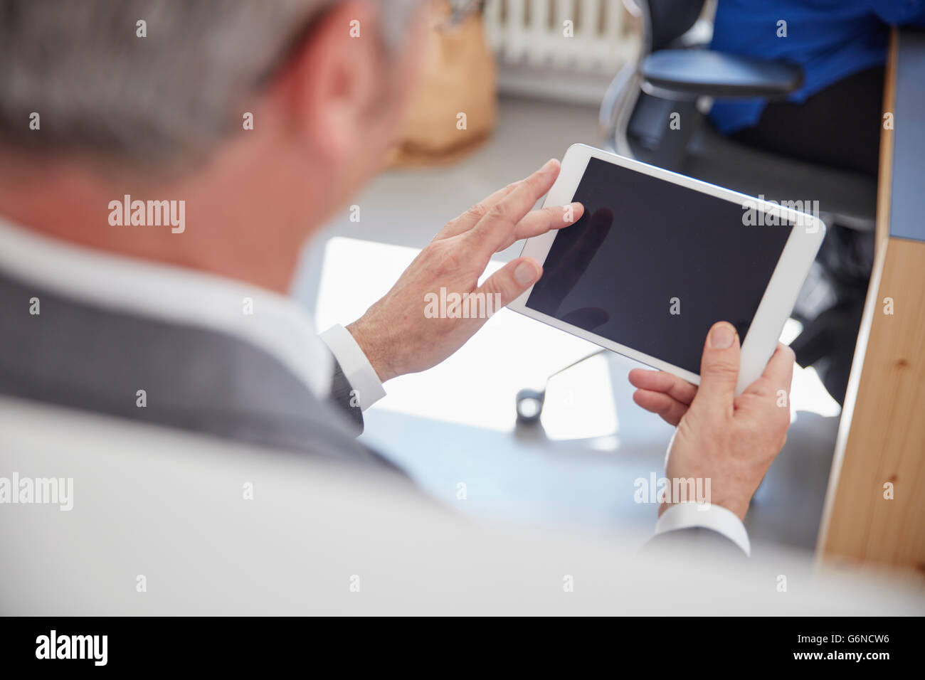 Mature man using digital tablet in office Stock Photo