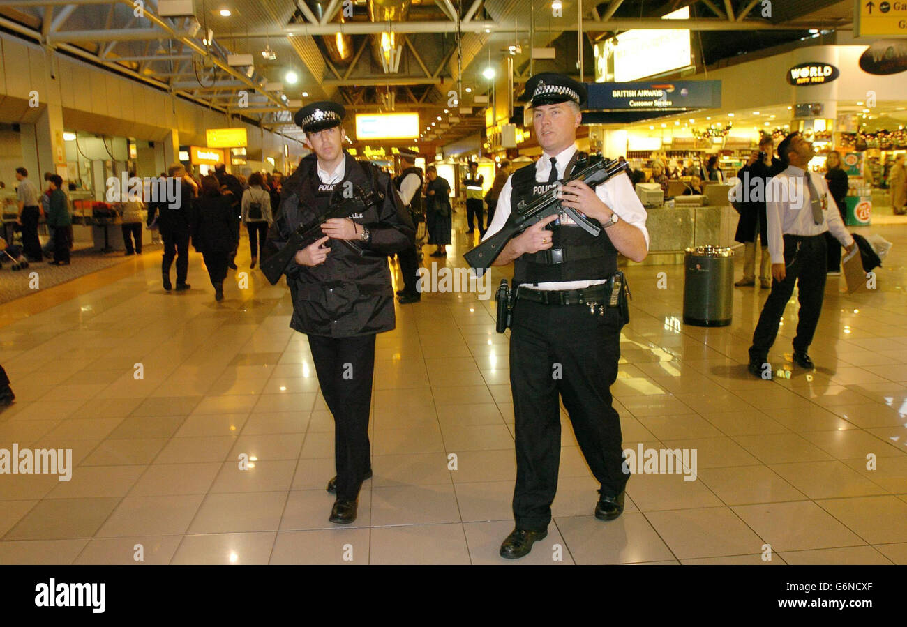 Armed police officers patrol terminal four londons heathrow airport hi