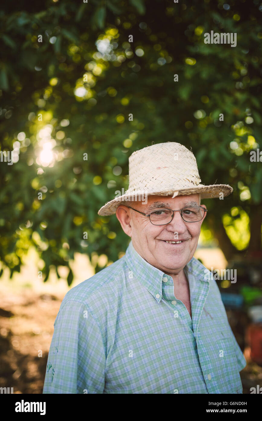 Portrait of smiling farmer wearing straw hat Stock Photo - Alamy